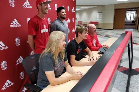 Tanner Meyer signing at WHS to attend Allen County to play basketball